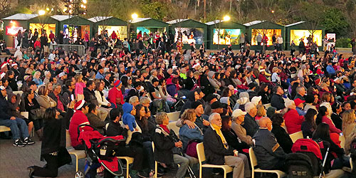 December Nights attendees sitting down and watching a show at the Organ Pavilion