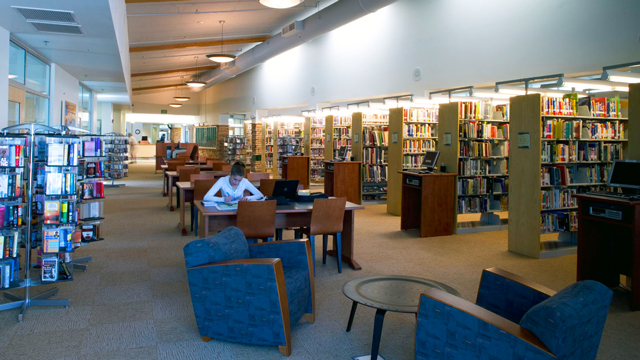 Reading area and book stacks inside the College-Rolando Library