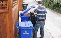 Photo of Man Scavenging Through Trash Bin