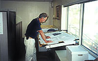 Photo of man looking over blueprints