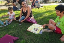 Kids reading outdoors