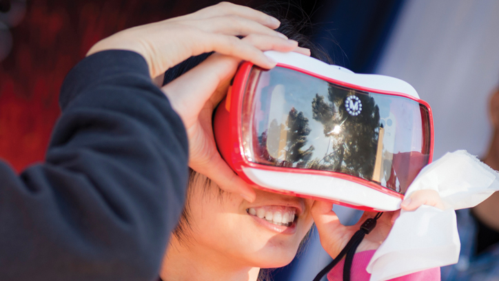 Photo of young girl using virtual reality headset