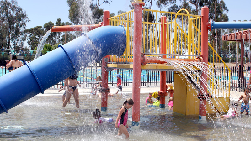 Children playing on the playground at the Tierrasanta Community Pool 