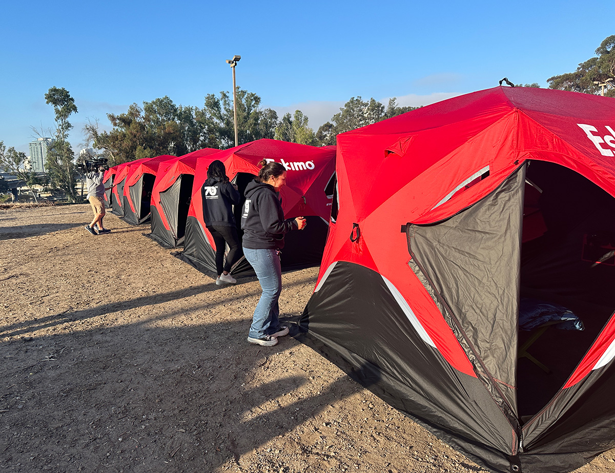 A row of tents lined up a safe sleeping site