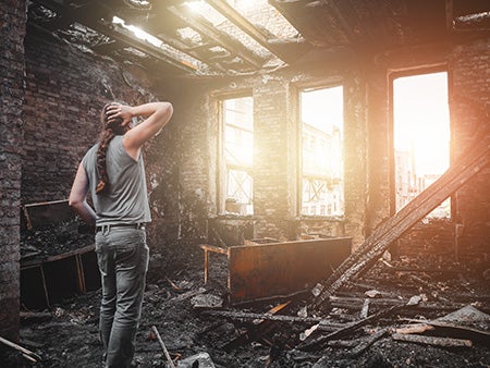 woman surveying fire damage