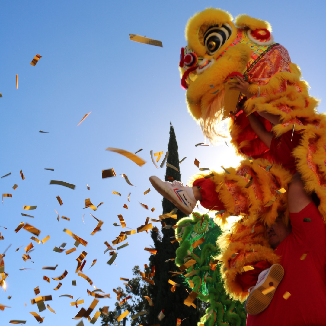 Lion Dancer jumping in air with confetti