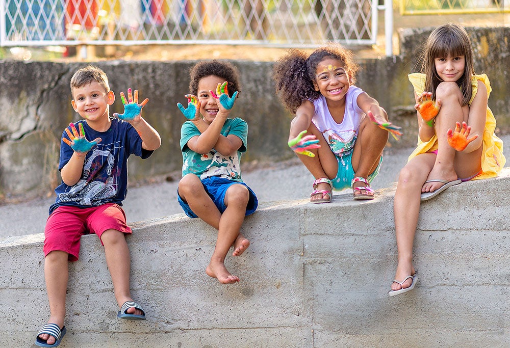 Cheerful kids showing their painted hands