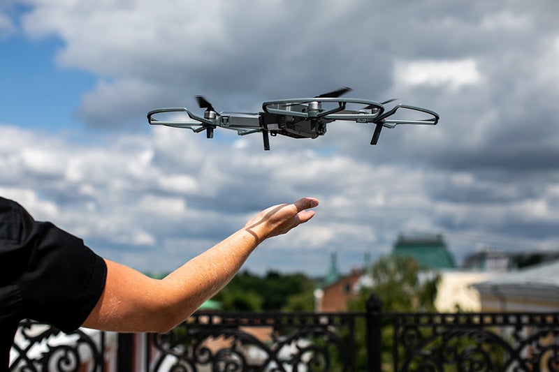 A drone landing on a person's hand