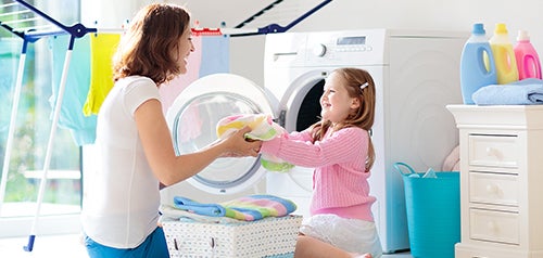 mother and child doing laundry