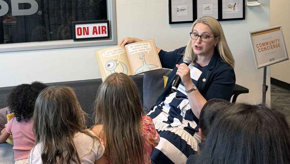 City Attorney Heather Ferbert reads to excited kids at the Your Safe Place backpack giveaway