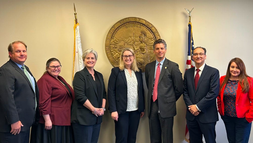 Group photo of City Attorney Ferbert, US Attorney Gordon and their teams