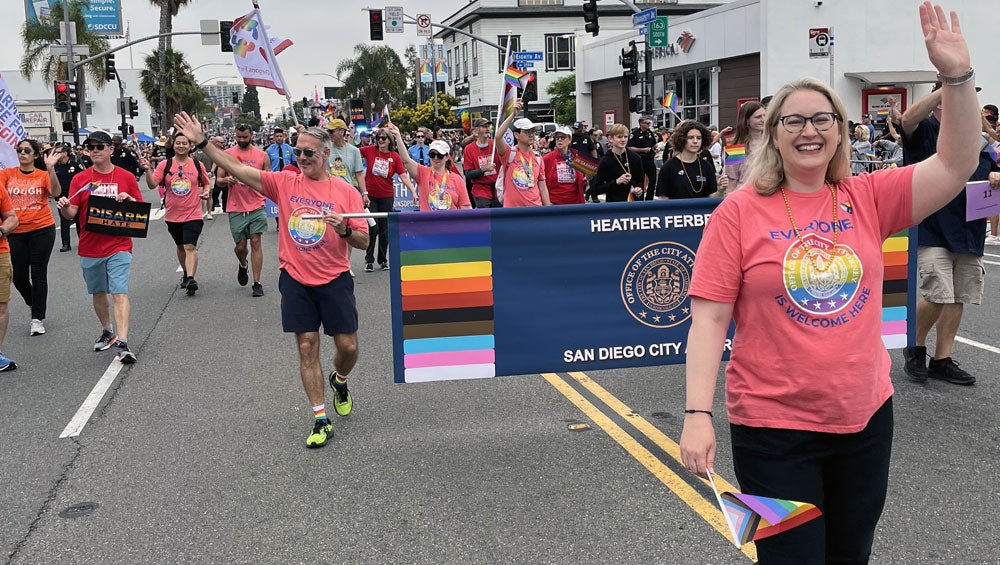 City Attorney Heather Ferbert walking with staff and community members at the Annual Pride Parade