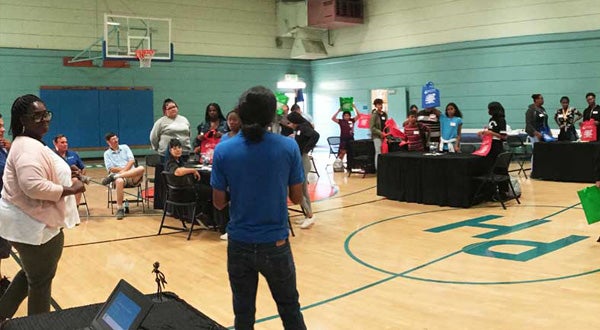 City staff leading a community engagement event in a gymnasium