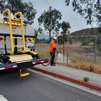City worker watering a tree