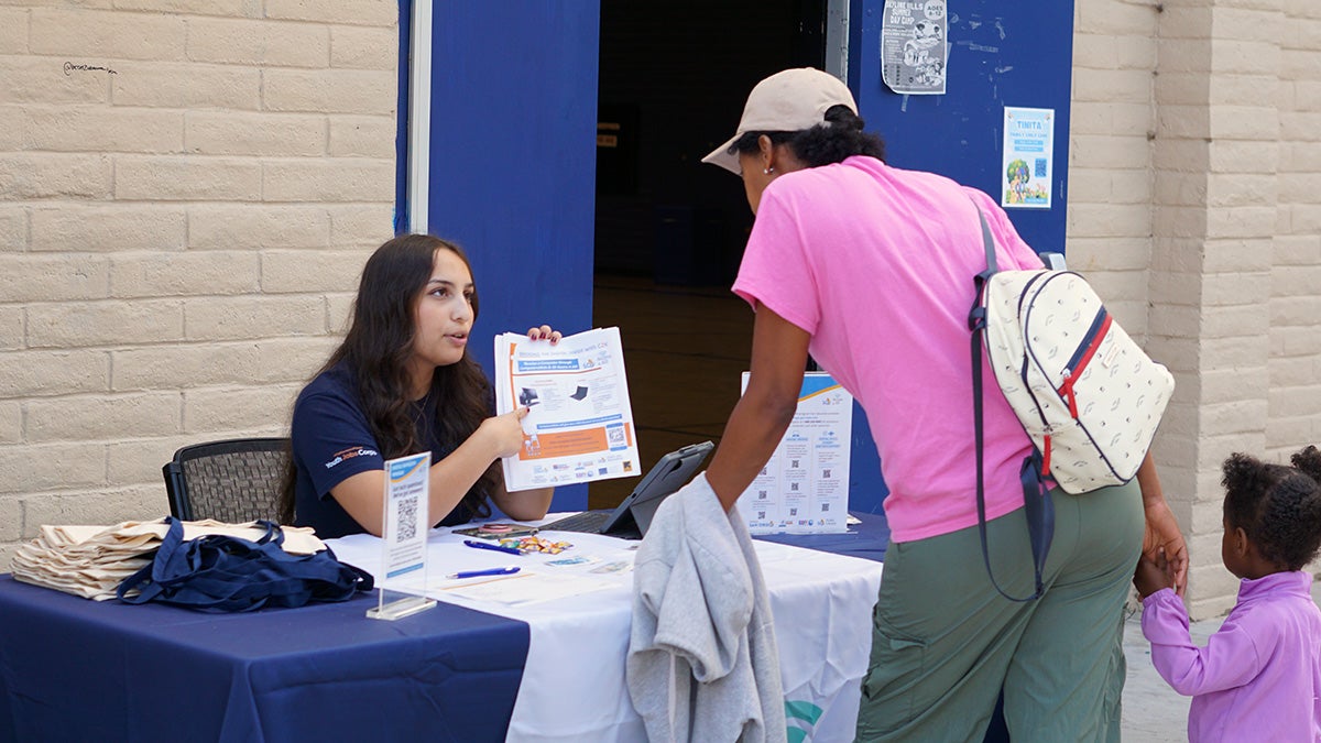 A Digital Navigator Program volunteer providing information at an outreach event