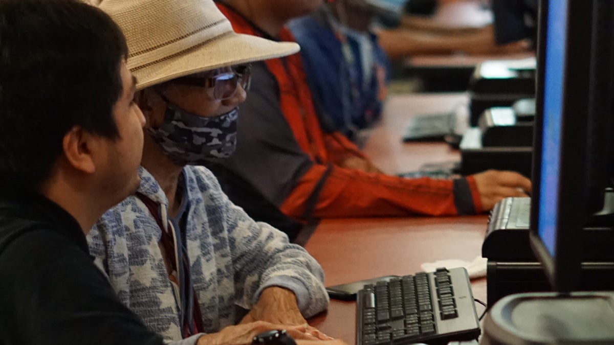 A Digital Navigator Program volunteer providing computer training