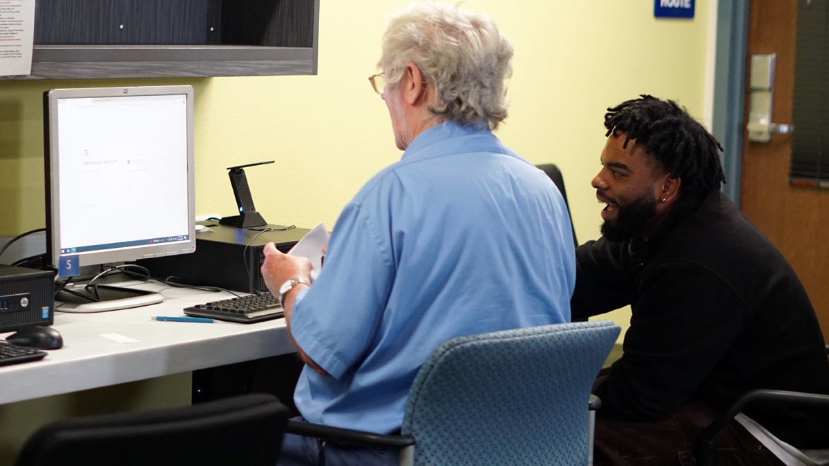 A Digital Navigator Program volunteer providing computer training