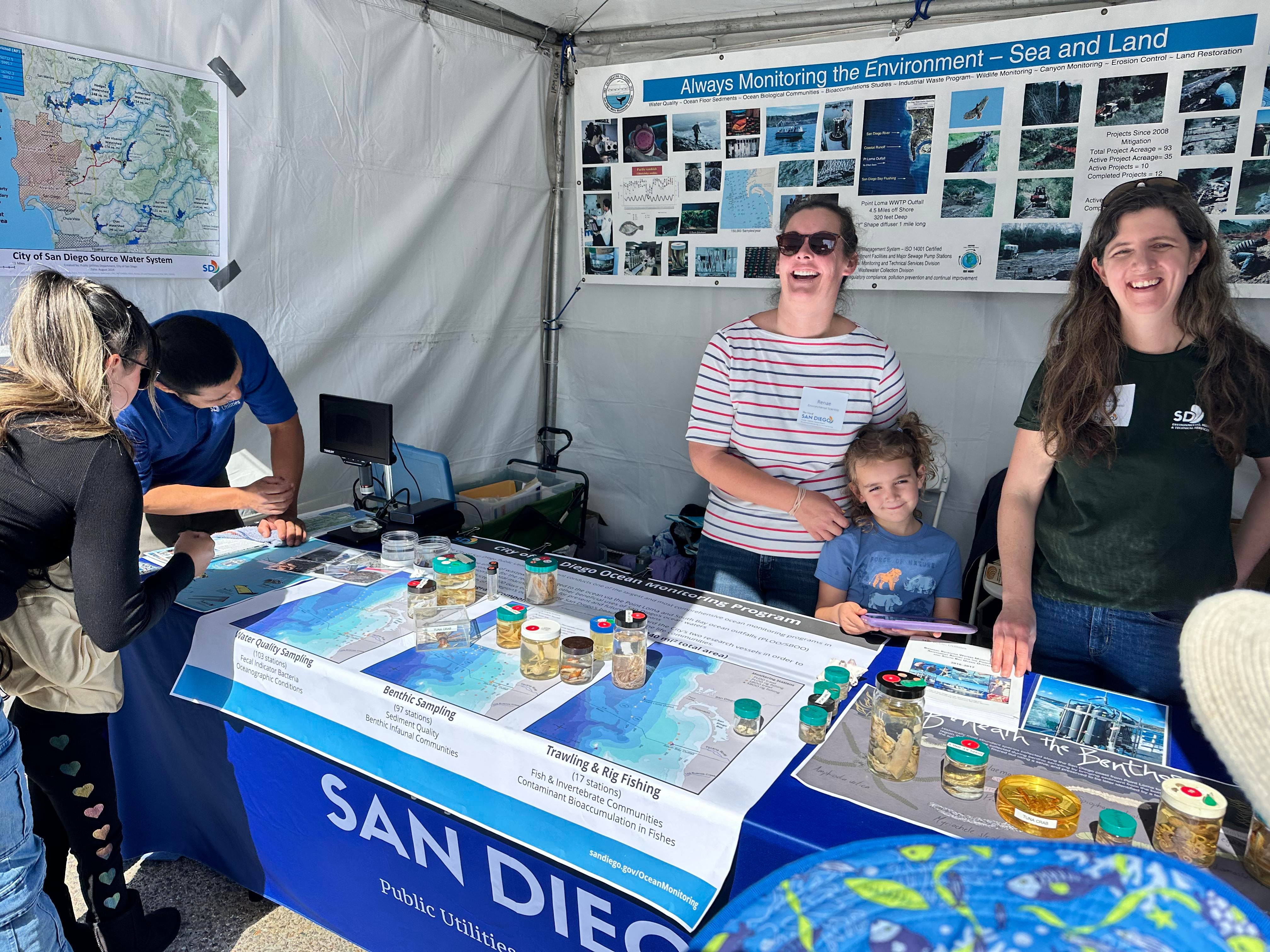 A marine biologist shows a member of the public invertebrates commonly found as part of the City's Ocean Monitoring Program.