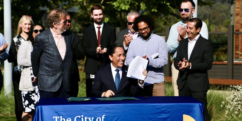 Mayor Todd Gloria signing