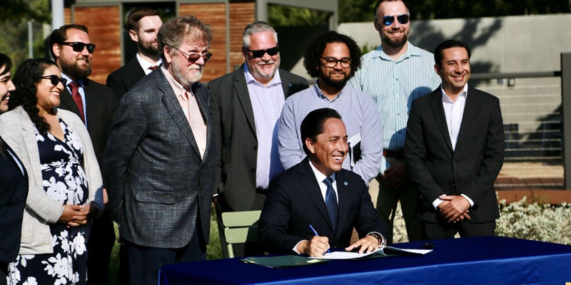 Mayor Todd Gloria signing