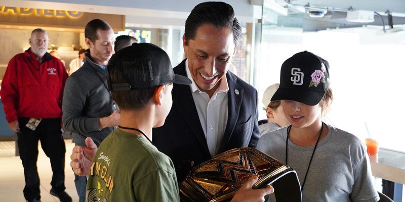 Mayor Todd Gloria with a WWE belt