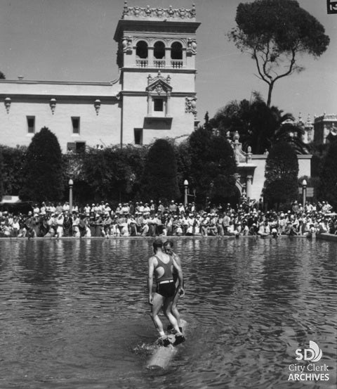 Two men compete in the log rolling game at the 1935 Expo