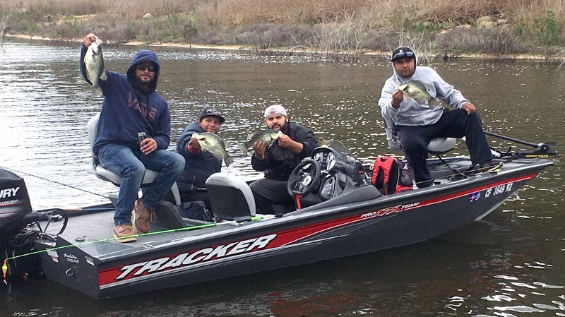 Anglers on a boat displaying their fish at Hodges Reservoir