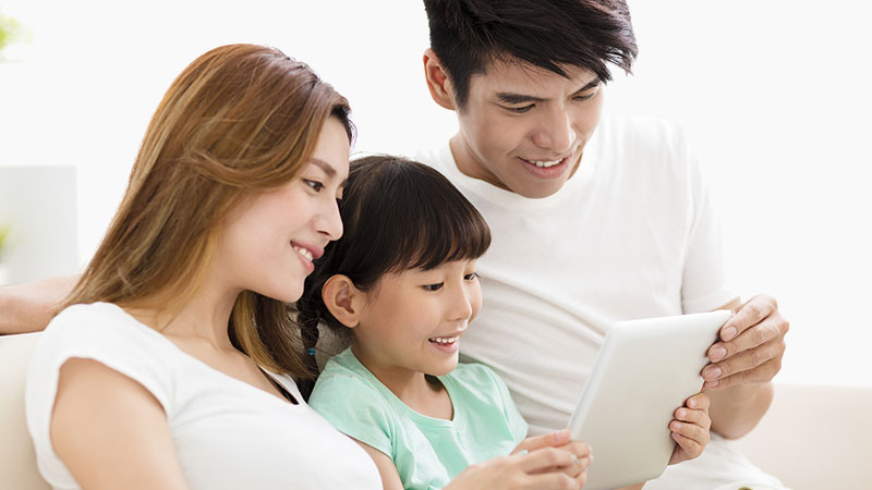 Asian family looking at tablet