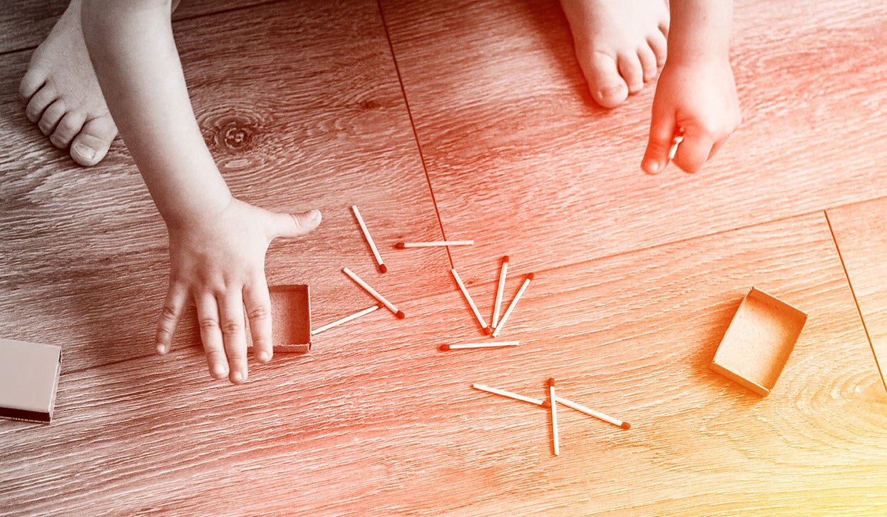 young child playing with matches
