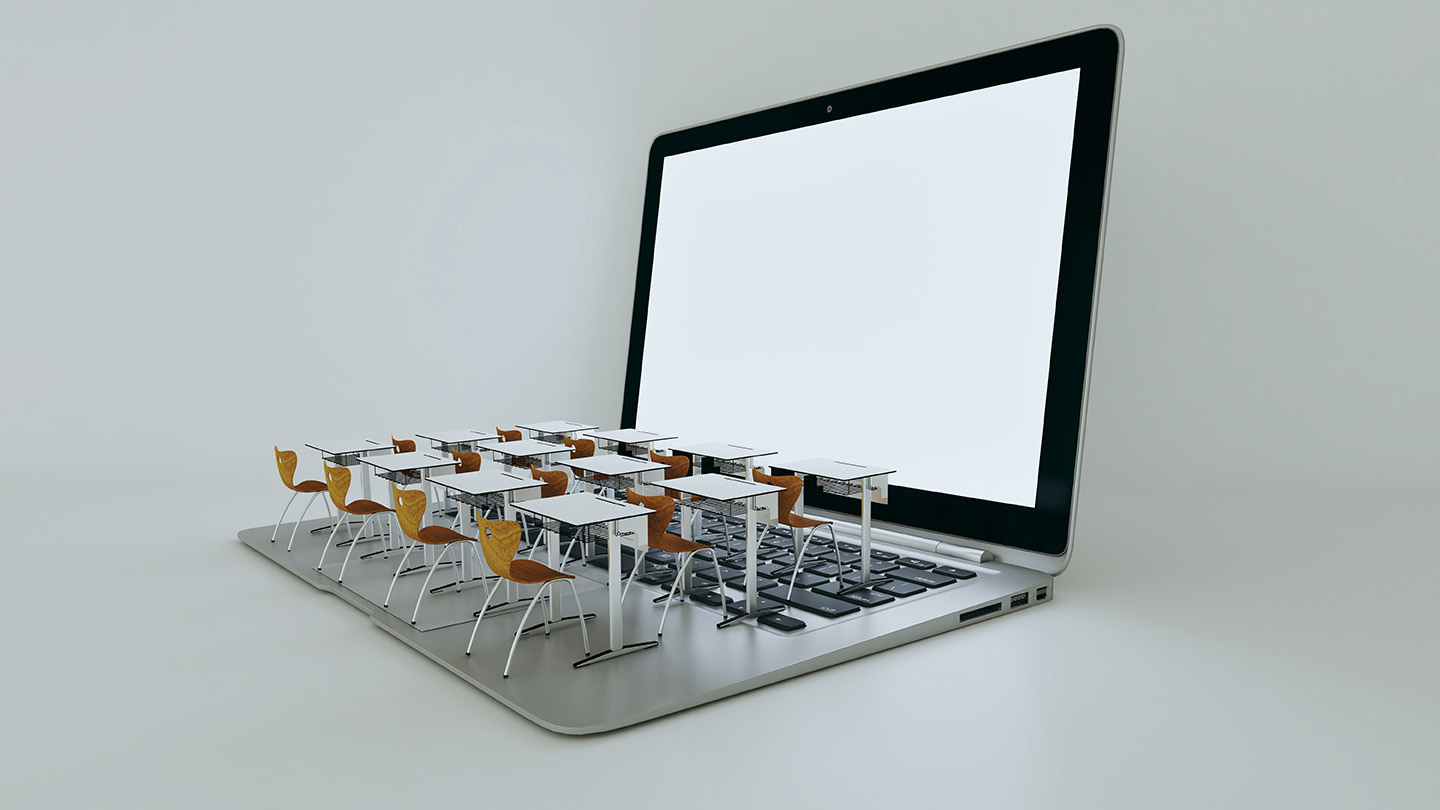 Image desks and chairs on top of a laptop keyboard, simulating a virtual classroom setting.