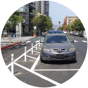 A bike lane next to a row of parked cars