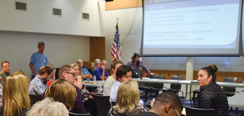 Community members engaged in a discussion in a community planning group meeting