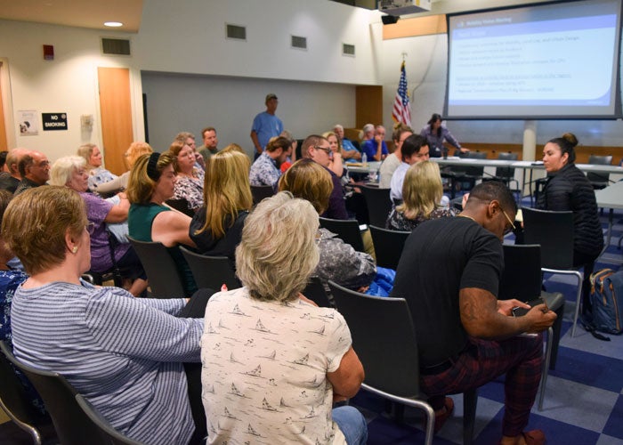 Community members engaged in a discussion in a community planning group meeting