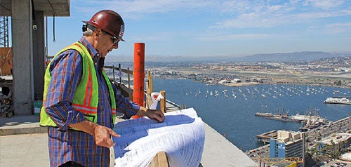 Building inspector looking at plans on top of the Central Library construction site