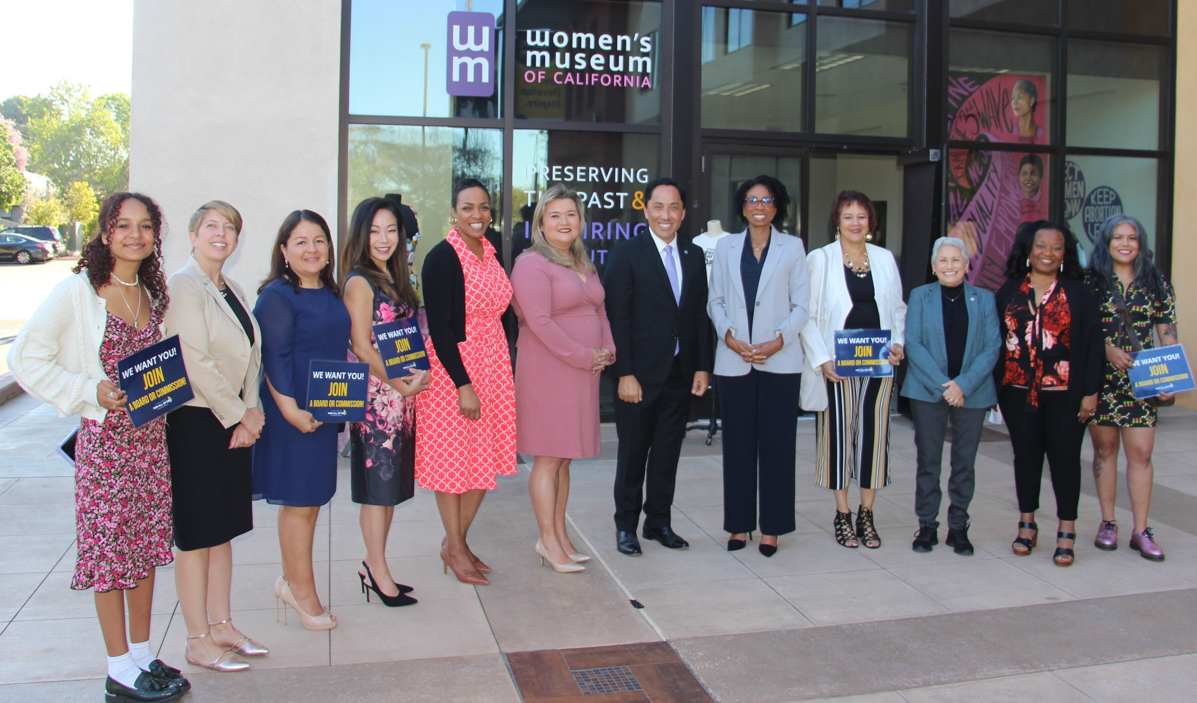 Mayor Todd Gloria and women in front of building 