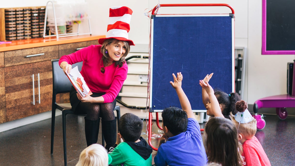 Photo of Councilmember Lorie Zapf reading Green Eggs and Ham to children.