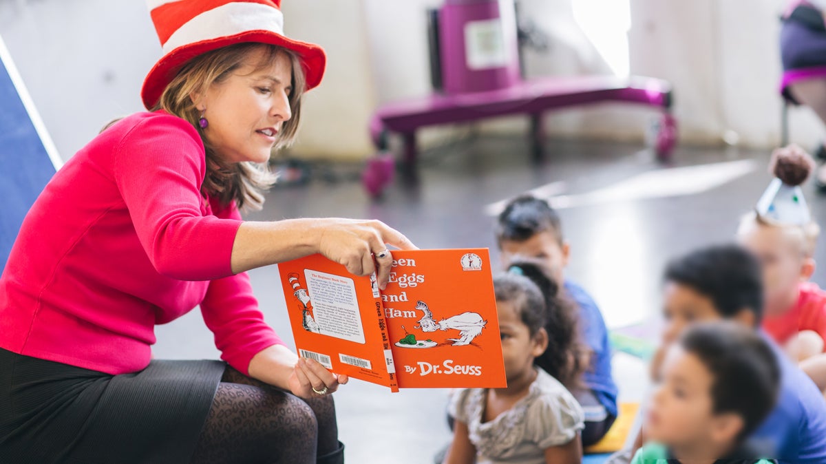Photo Councilmember Lorie Zapf reading Green Eggs and Ham to children.