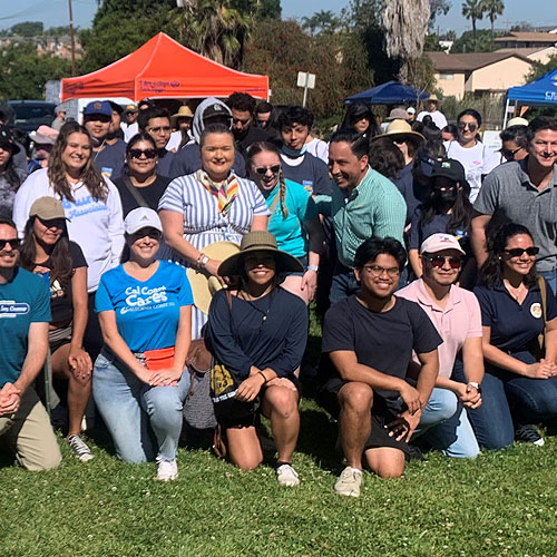 Mayor Todd Gloria and Councilmember Vivial Moreno posing with other volunteers at a cleanup event