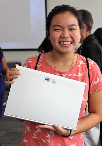 Young person holding a laptop