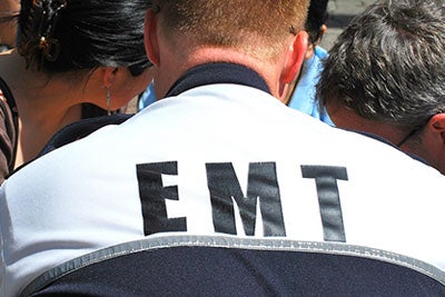 Photo of EMT working on a patient
