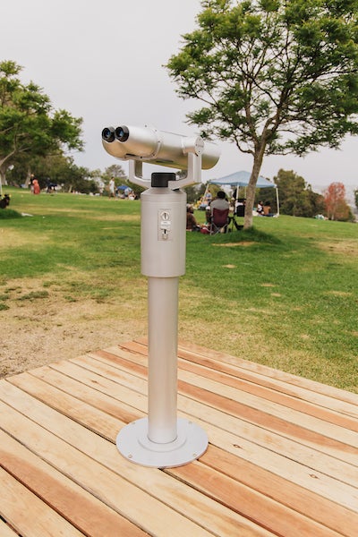 A pair of binoculars that displays video vignettes of everyday workers who make the city of San Diego run