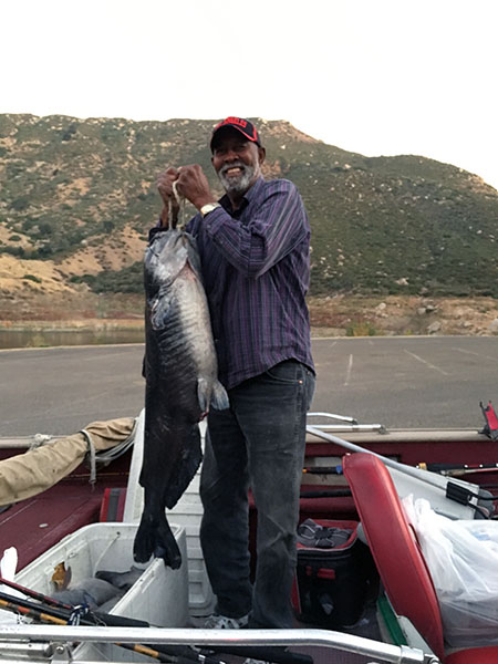 Angler displaying fish caught at reservoir lake