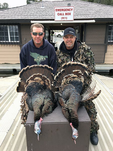 Hunters displaying turkey caught at Sutherland Reservoir