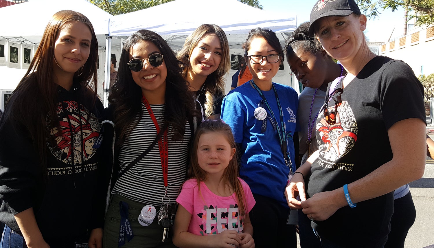 Photo of Freedom Now Fair attendees wearing the City's Blue ribbon in solidarity.