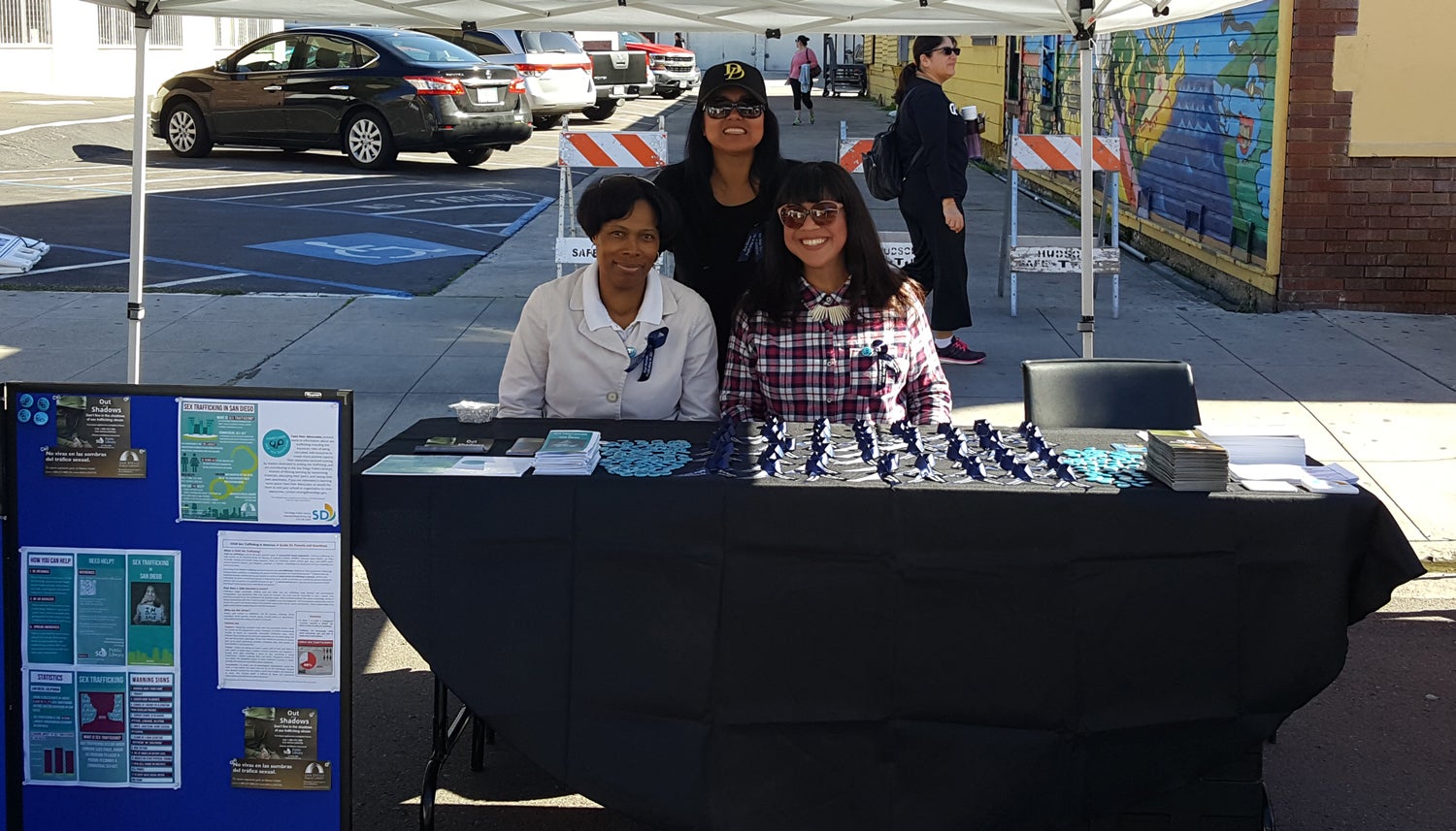 Photo of Library staff working the booth at the Freedom Now Fair.