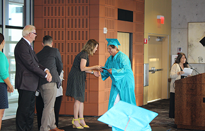 Graduate shaking hands with library director