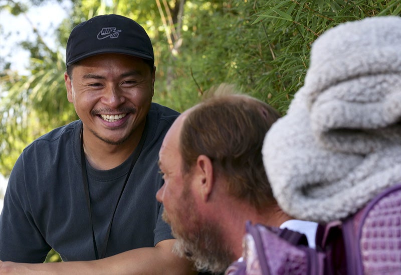 Outreach team member talking to a man experiencing homelessness