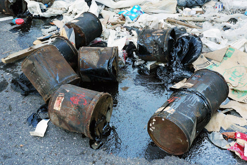 Hazardous oil dumped illegally on pavement