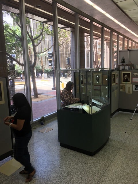 City volunteers preparing San Diego Mayors exhibit in City Administration Building