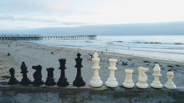 Chess pieces in front of a pier